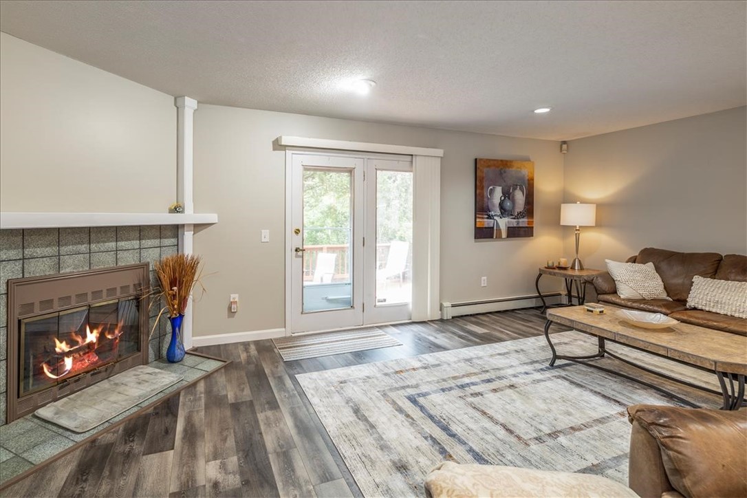 2 Quartz Drive, Unit 2A Westerly, RI 02891 - Photo 7 of 20 Living Room fireplace and access to private deck