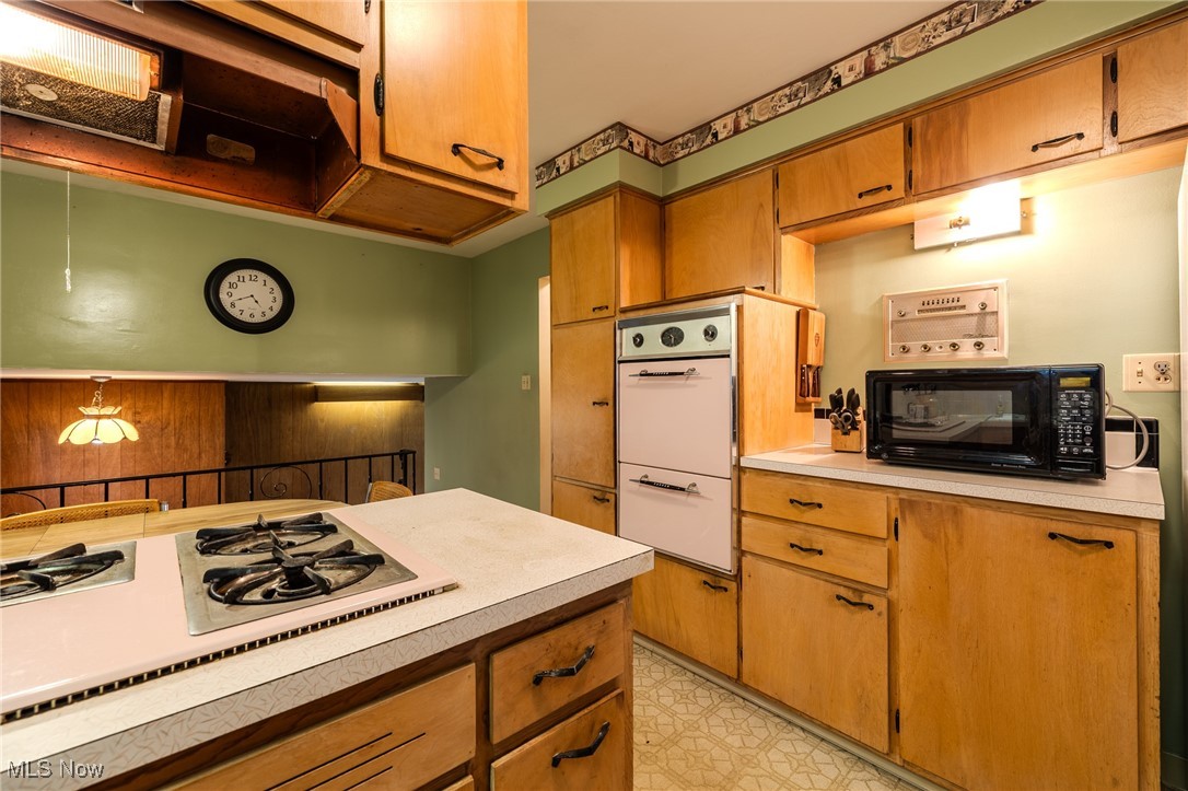 1950 Rush Road Wickliffe, OH 44092 - Photo 33 of 50 Kitchen featuring brown cabinetry, light countertops, and white appliances