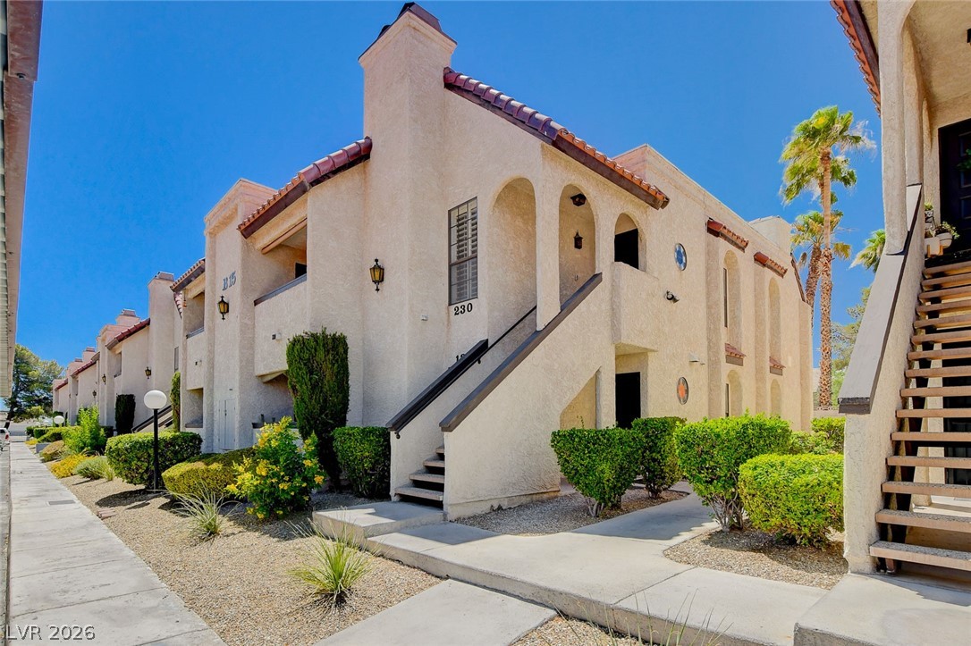 1751 East Reno Avenue, Unit 228 Las Vegas, NV 89119 - Photo 1 of 39 Spanish-style architecture with arched doorways and terracotta-tiled roofs creates a charming desert oasis.
