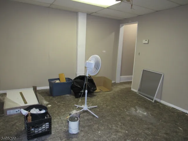 an empty room with a empty space and chandelier fan