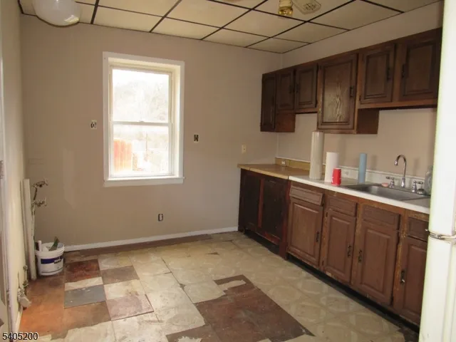 a kitchen with a sink a refrigerator and cabinets