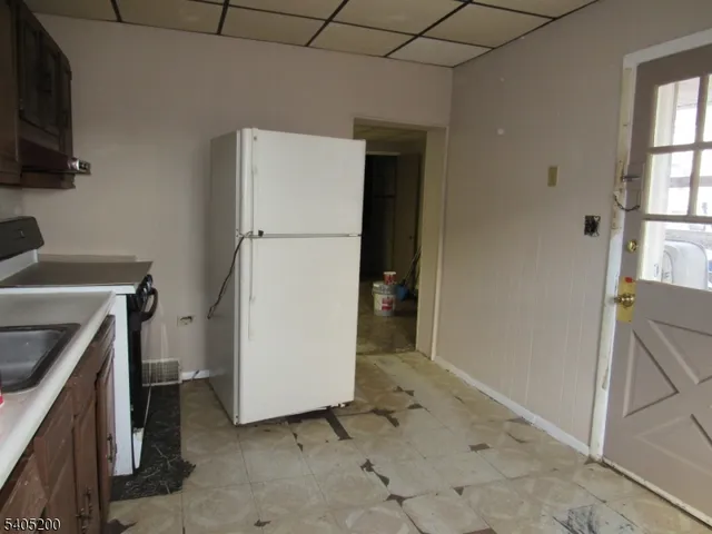 a room with lots of appliances and a wooden floor