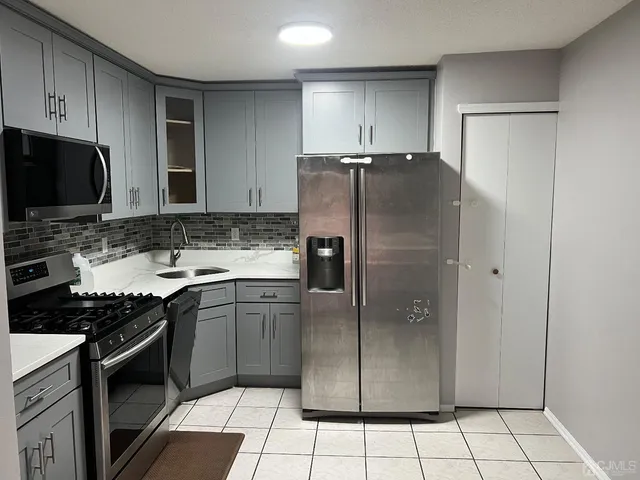 a kitchen with granite countertop a stove and a sink