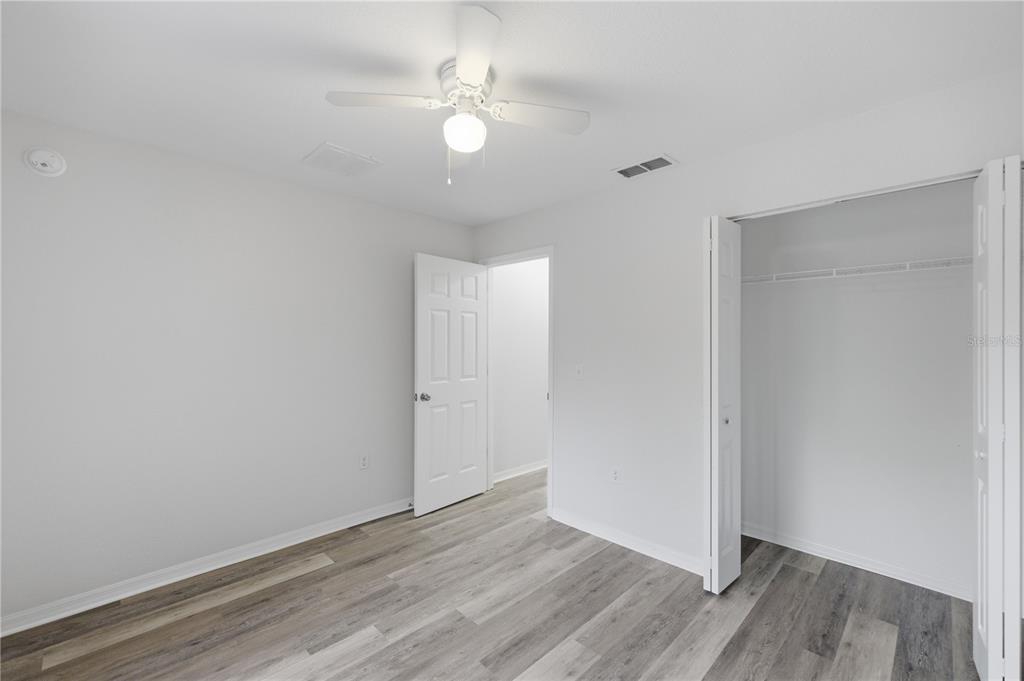 14185 Southwest 28th Lane Ocala, FL 34481 - Photo 11 of 12 a view of an empty room with wooden floor