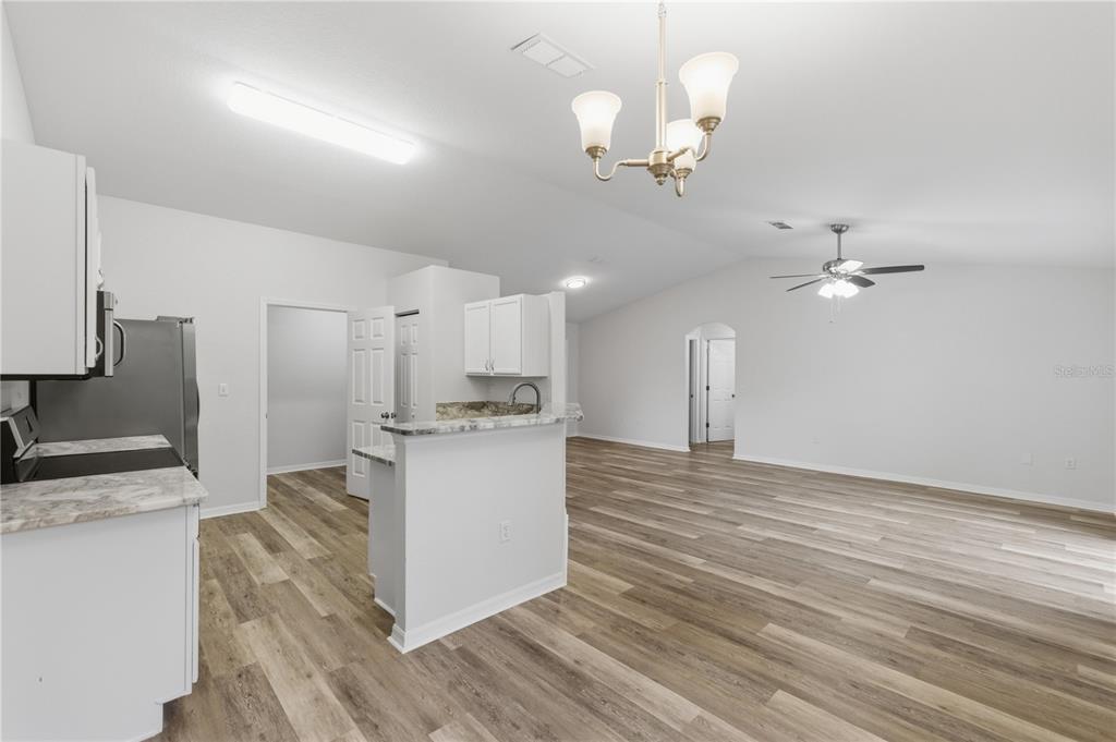 14185 Southwest 28th Lane Ocala, FL 34481 - Photo 4 of 12 a view of a kitchen with a sink and chandelier