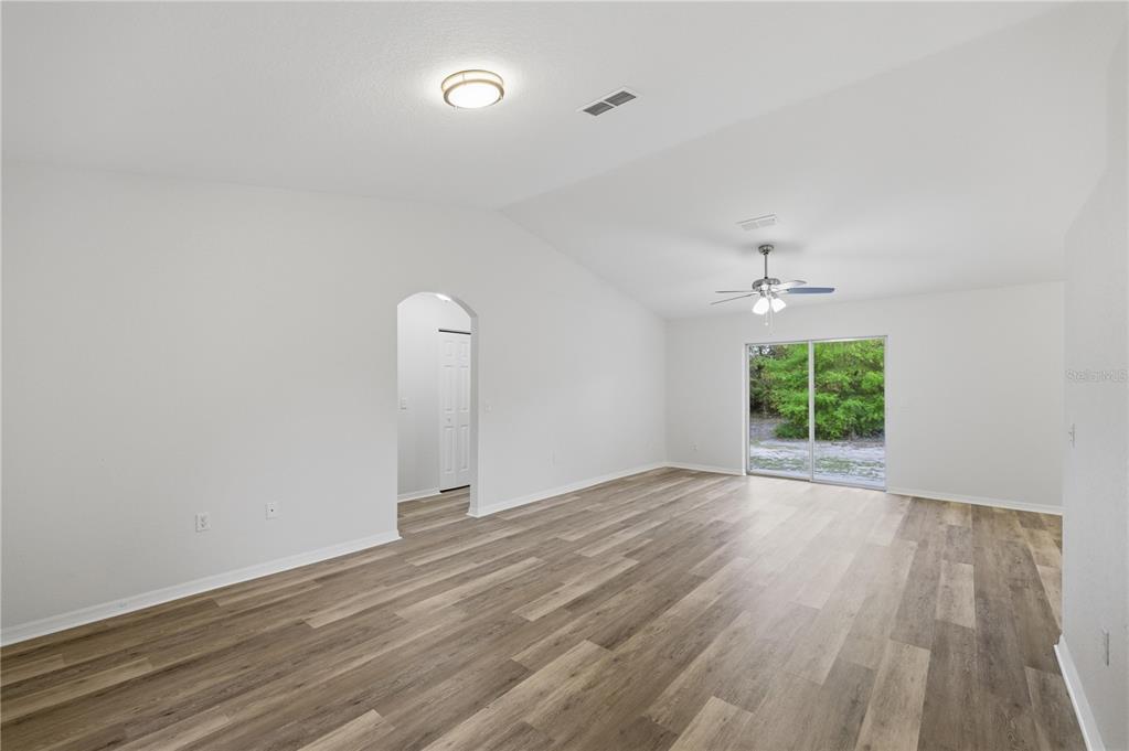 14185 Southwest 28th Lane Ocala, FL 34481 - Photo 8 of 12 wooden floor in an empty room with a window