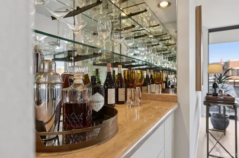 a white bath tub sitting next to a white toilet and vanity