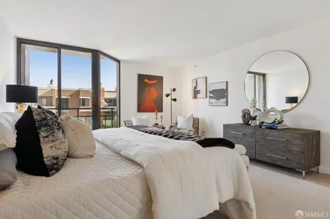 a bedroom with a large bed a desk and chair