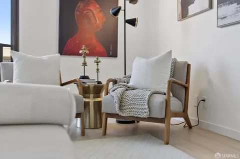 a bedroom with furniture and a large window