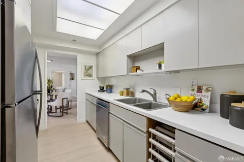 a dining room with furniture and a floor to ceiling window