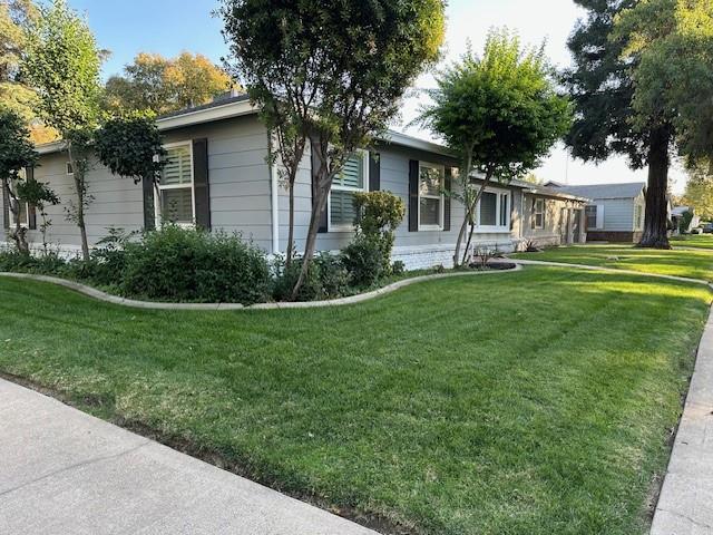 2550 4th Avenue Merced, CA 95340 - Photo 32 of 34 a front view of a house with a garden and trees
