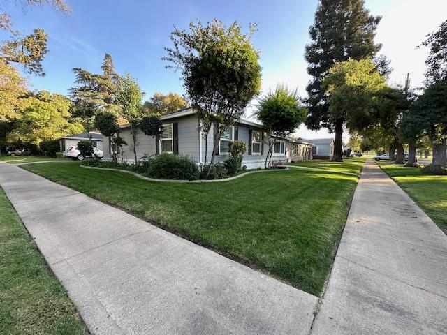 2550 4th Avenue Merced, CA 95340 - Photo 33 of 34 a front view of a house with a yard and potted plants