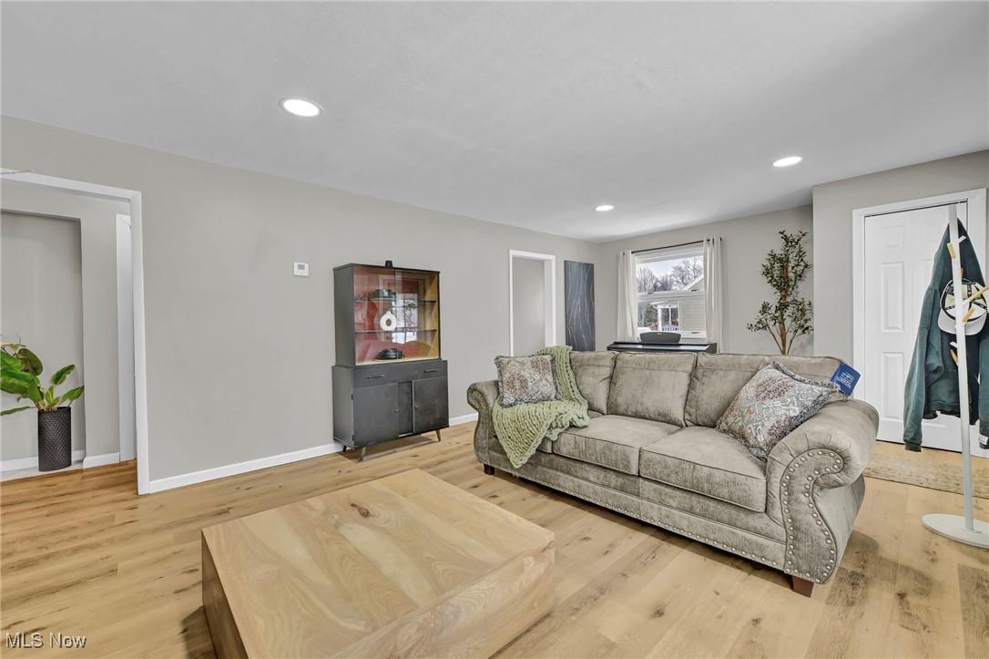 Living room with recessed lighting and light wood finished floors