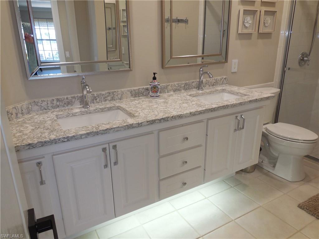 5441 Guadeloupe Way Naples, FL 34119 - Photo 17 of 45 Bathroom with toilet, tile patterned flooring, a sink, and double vanity