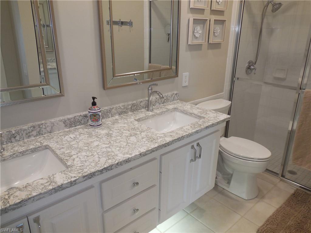 5441 Guadeloupe Way Naples, FL 34119 - Photo 18 of 45 Full bathroom with a shower stall, toilet, and a sink