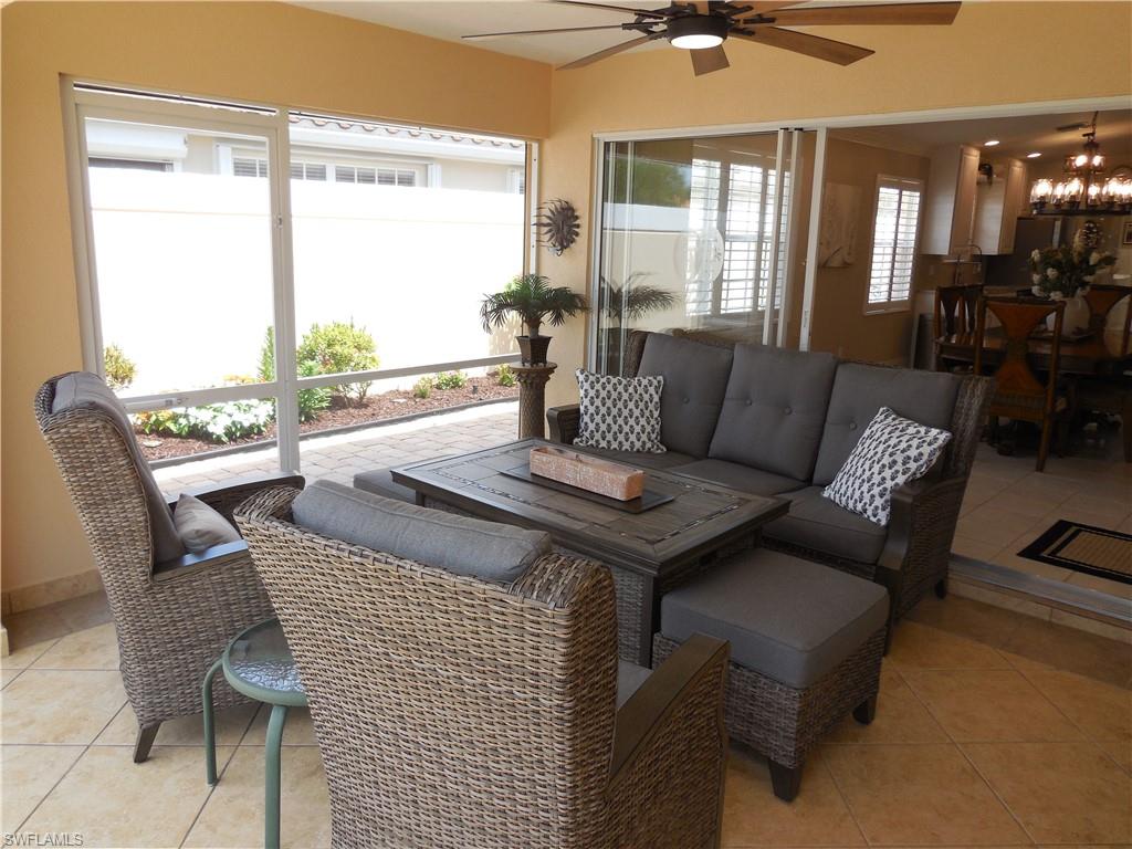5441 Guadeloupe Way Naples, FL 34119 - Photo 25 of 45 Sunroom / solarium with tile patterned flooring and a notable chandelier