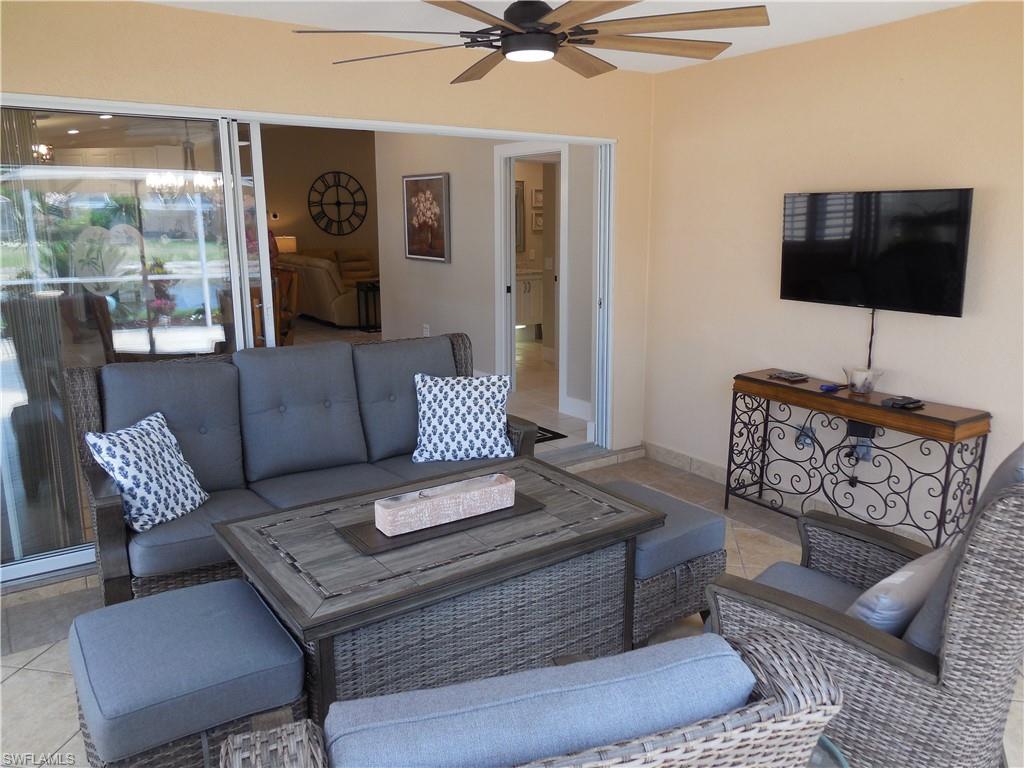 5441 Guadeloupe Way Naples, FL 34119 - Photo 3 of 45 Tiled living room featuring a ceiling fan