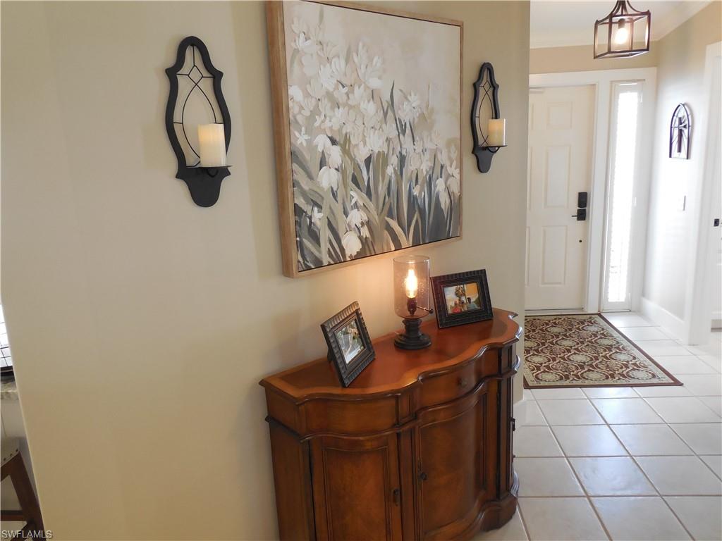 5441 Guadeloupe Way Naples, FL 34119 - Photo 6 of 45 Entrance foyer featuring plenty of natural light and light tile patterned floors