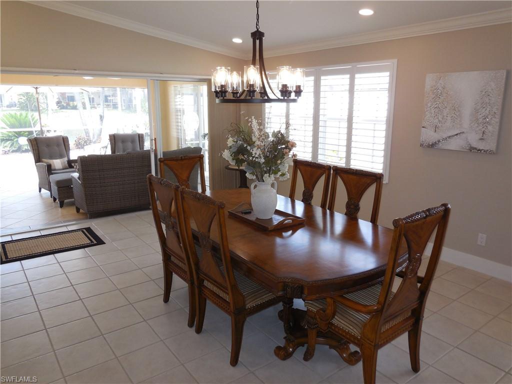 5441 Guadeloupe Way Naples, FL 34119 - Photo 8 of 45 Dining room featuring an inviting chandelier, recessed lighting, and light tile patterned floors