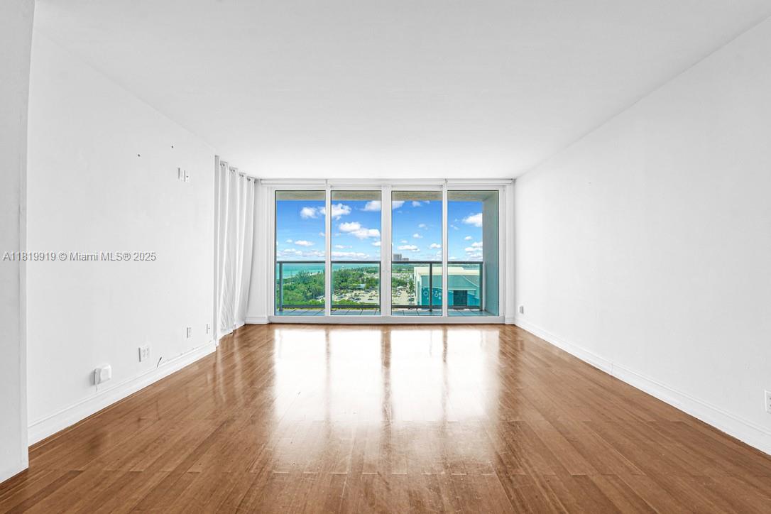 100 Bayview Drive, Unit 1223 Sunny Isles Beach, FL 33160 - Photo 13 of 34 wooden floor in an empty room with a window
