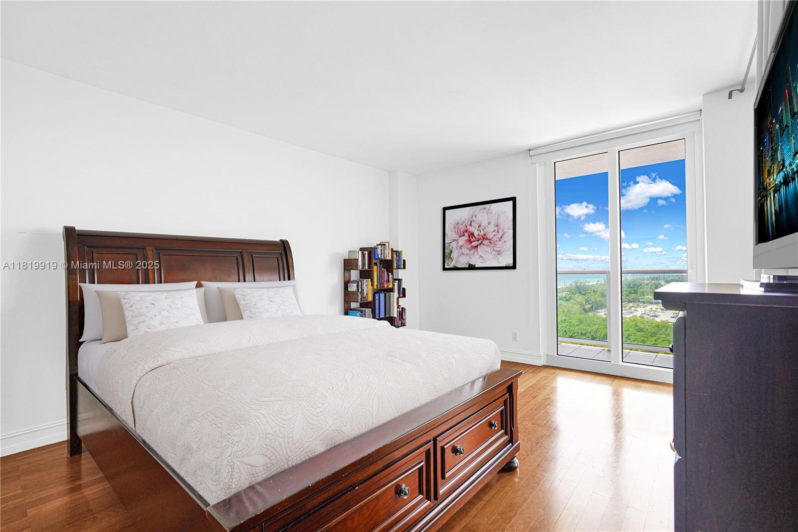 100 Bayview Drive, Unit 1223 Sunny Isles Beach, FL 33160 - Photo 17 of 34 a bedroom with a bed and a large window