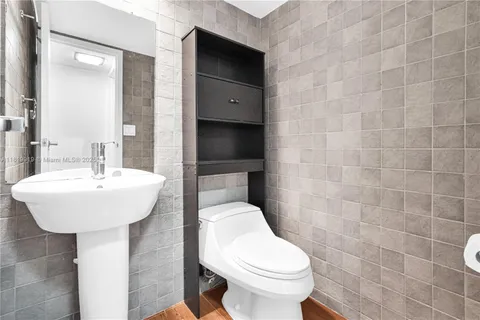 a bathroom with a sink a toilet and mirror