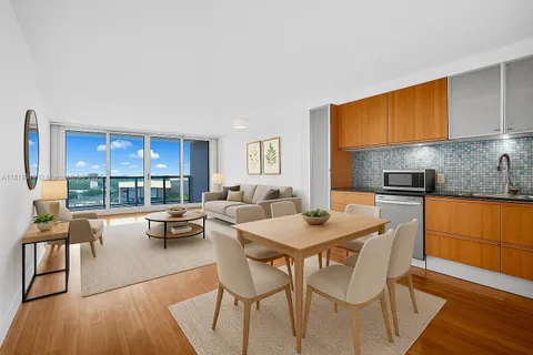 a dining room with a table chairs and a kitchen view