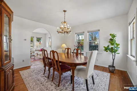a view of a dining room with furniture and chandelier