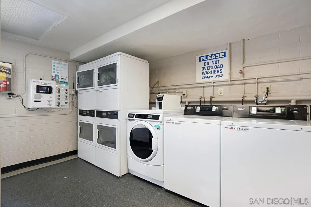 2510 Torrey Pines Road, Unit 408 La Jolla, CA 92037 - Photo 13 of 15 a kitchen with cabinets and white appliances