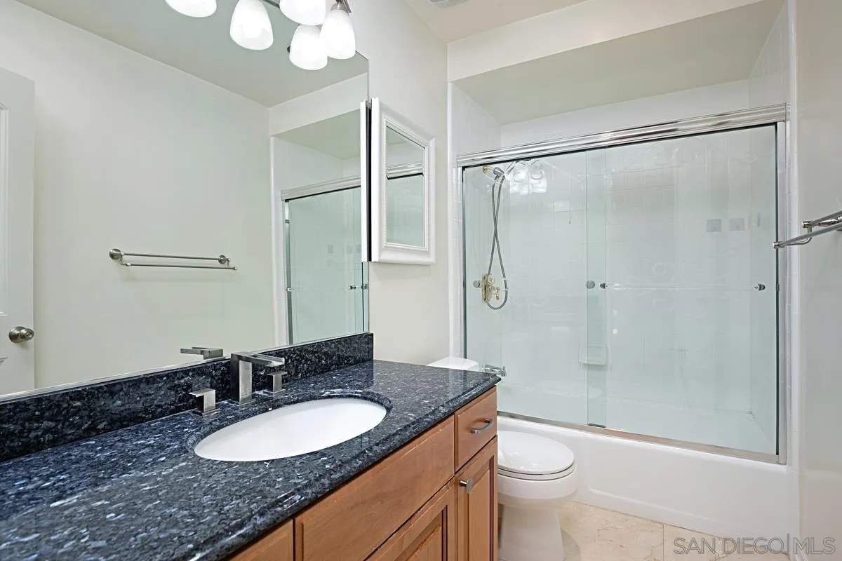 2510 Torrey Pines Road, Unit 408 La Jolla, CA 92037 - Photo 6 of 15 a bathroom with a granite countertop sink toilet and shower