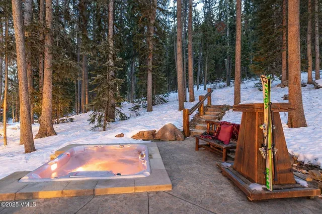a living room with furniture and floor to ceiling windows