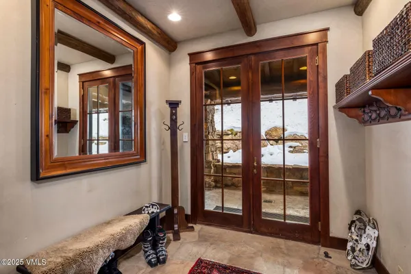 a dining room with furniture and a floor to ceiling window
