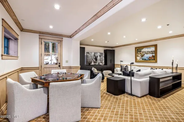 a living room with furniture and a floor to ceiling window