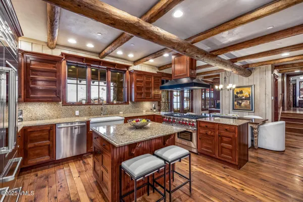 a kitchen with lots of counter top space and wooden floor