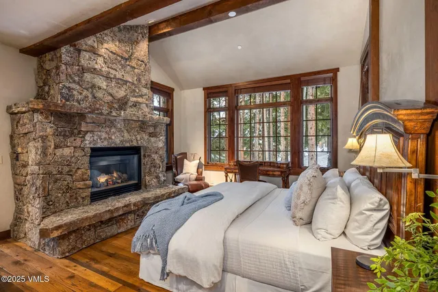 a bedroom with a bed and a fireplace