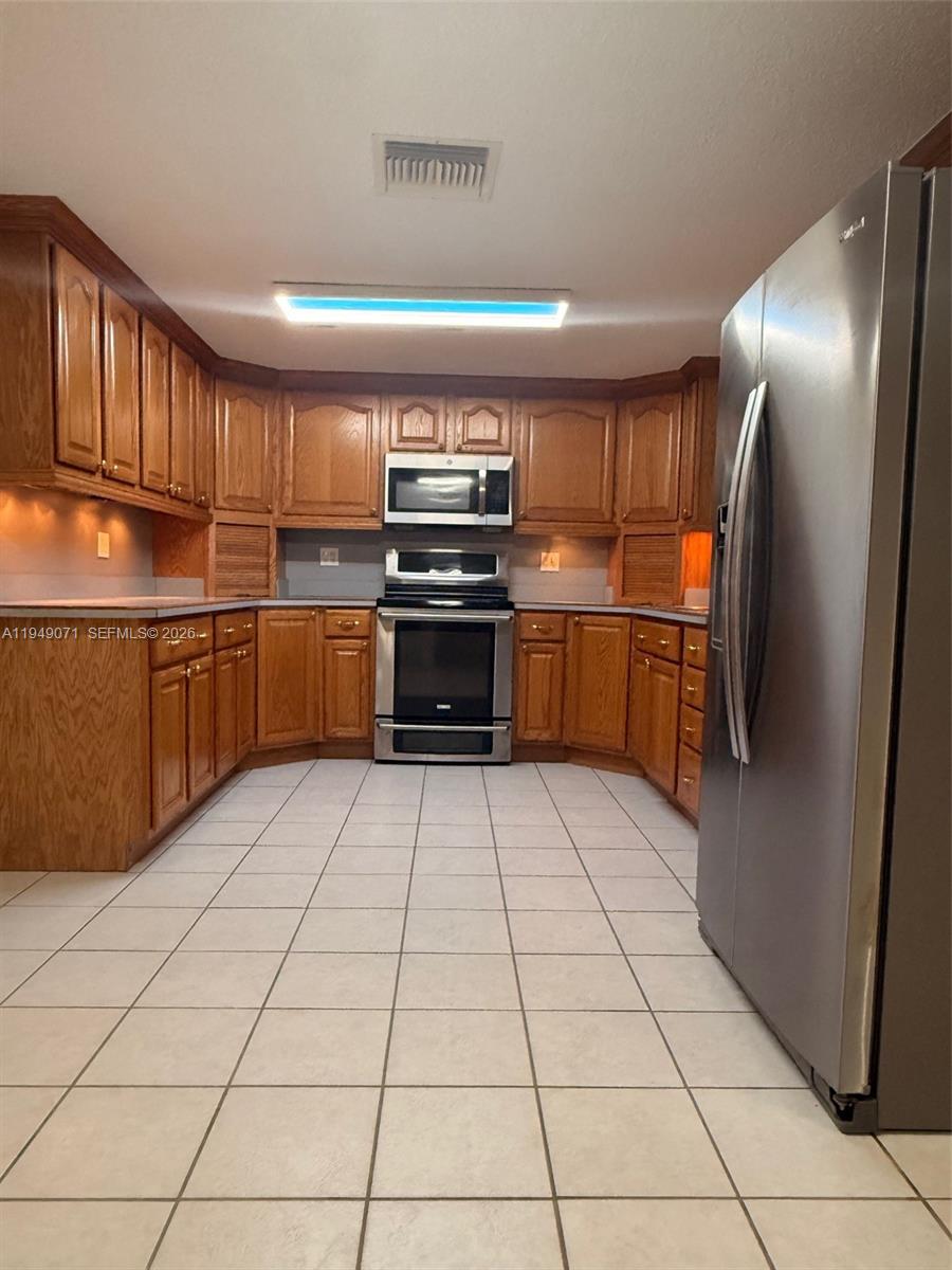 3709 Grand Concourse Sebring, FL 33875 - Photo 11 of 74 a kitchen with stainless steel appliances granite countertop a refrigerator and a stove top oven
