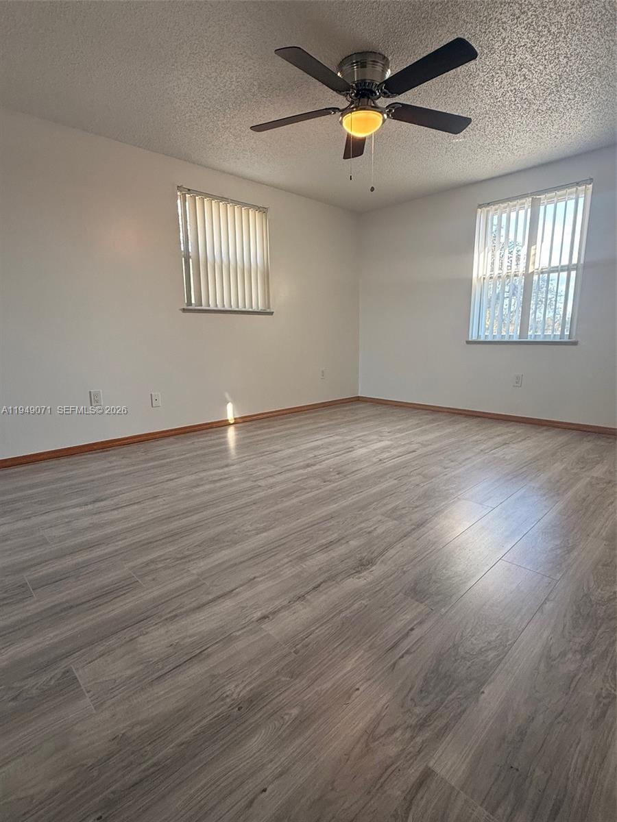 3709 Grand Concourse Sebring, FL 33875 - Photo 23 of 74 an empty room with wooden floor and windows