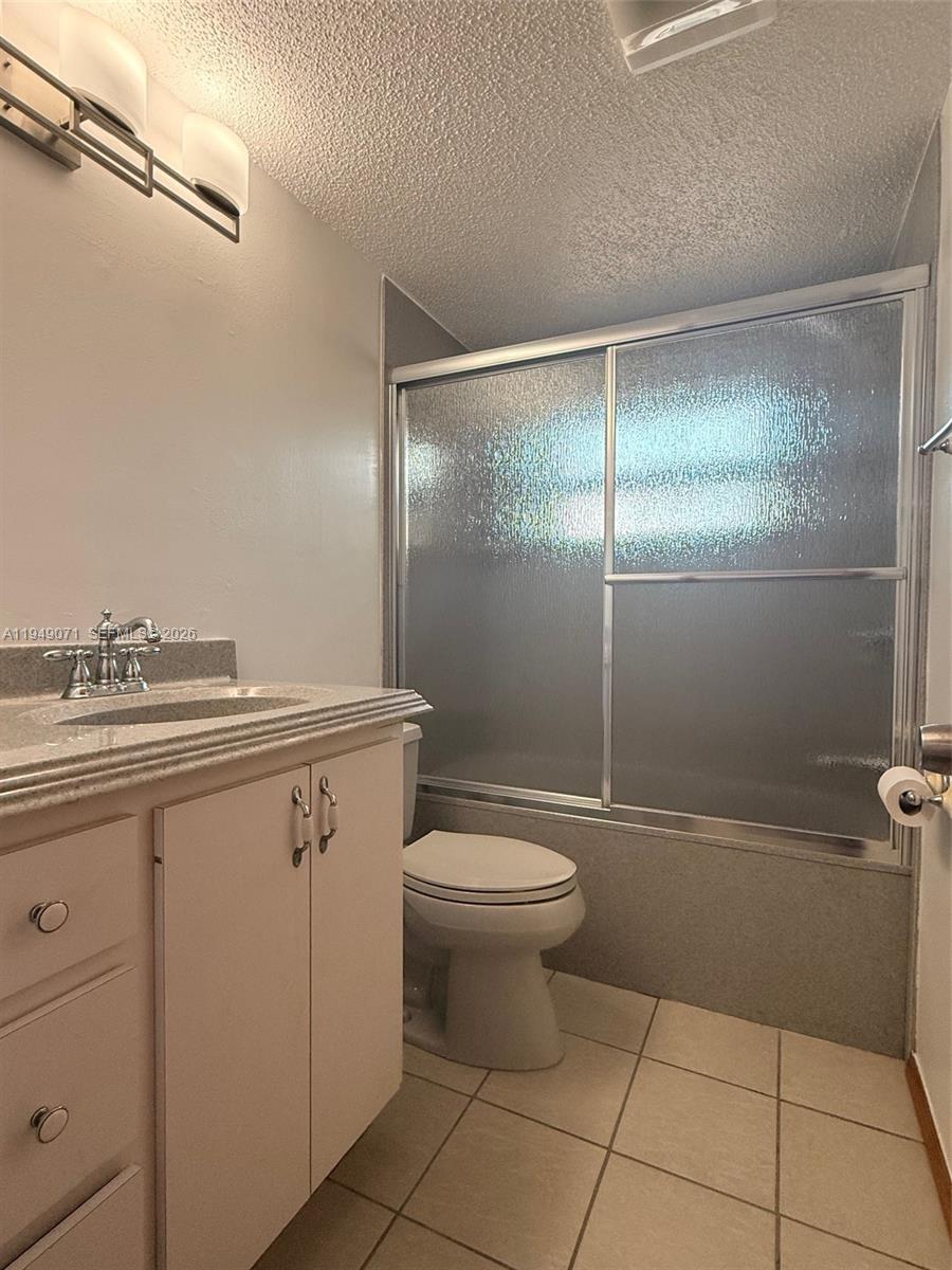 3709 Grand Concourse Sebring, FL 33875 - Photo 24 of 74 a bathroom with a granite countertop sink a toilet and a shower