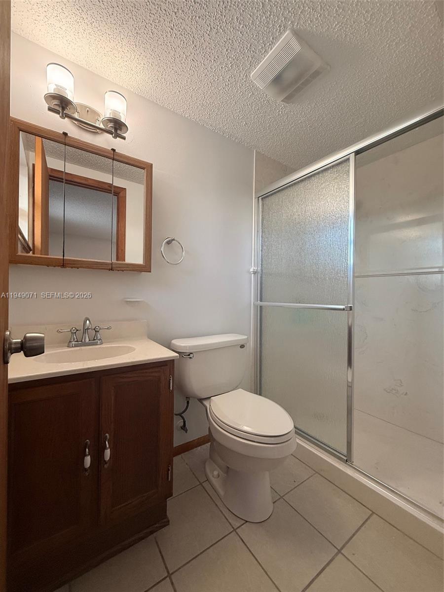 3709 Grand Concourse Sebring, FL 33875 - Photo 28 of 74 a bathroom with a toilet a sink and mirror