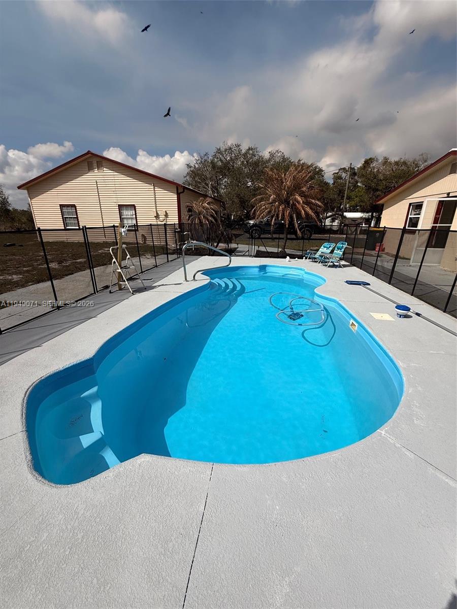 3709 Grand Concourse Sebring, FL 33875 - Photo 34 of 74 a swimming pool with outdoor seating and yard