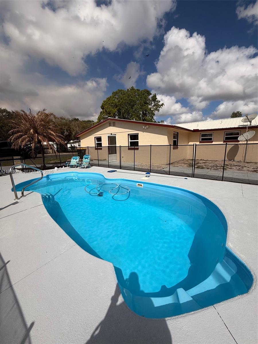 3709 Grand Concourse Sebring, FL 33875 - Photo 35 of 74 a view of a swimming pool with an outdoor seating and hardwood