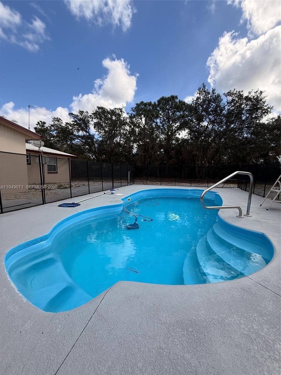 3709 Grand Concourse Sebring, FL 33875 - Photo 36 of 74 a view of a swimming pool with an outdoor seating