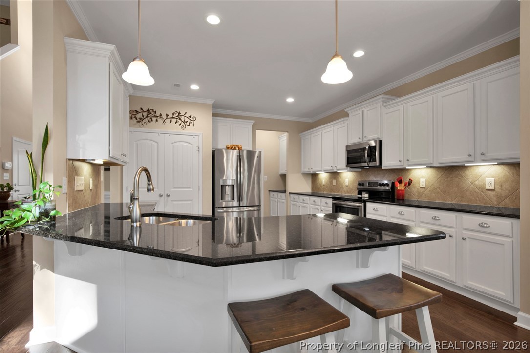 207 Pinetop Drive Carthage, NC 28327 - Photo 14 of 50 a kitchen with stainless steel appliances granite countertop a sink a stove and a microwave