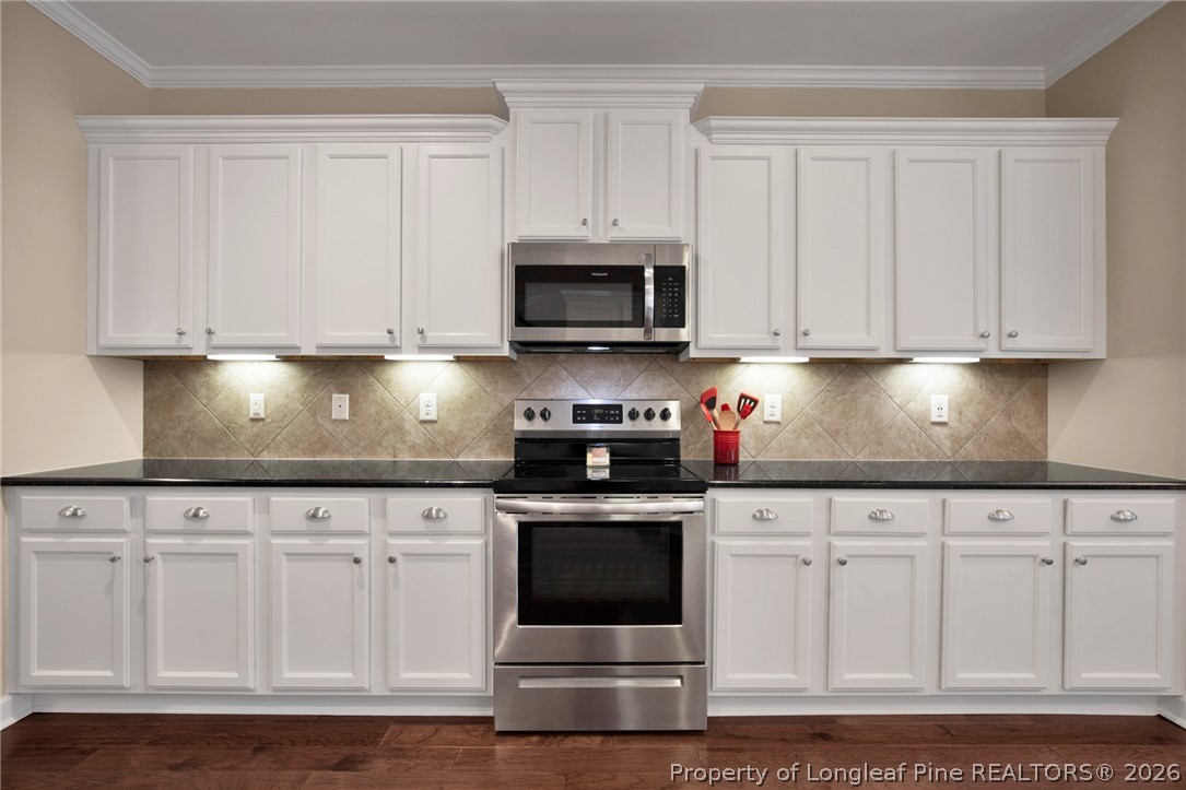 207 Pinetop Drive Carthage, NC 28327 - Photo 16 of 50 a kitchen with granite countertop white cabinets and stainless steel appliances