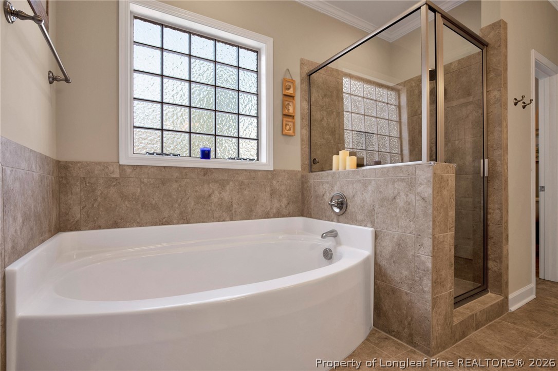 207 Pinetop Drive Carthage, NC 28327 - Photo 26 of 50 a bathroom with a bathtub and window