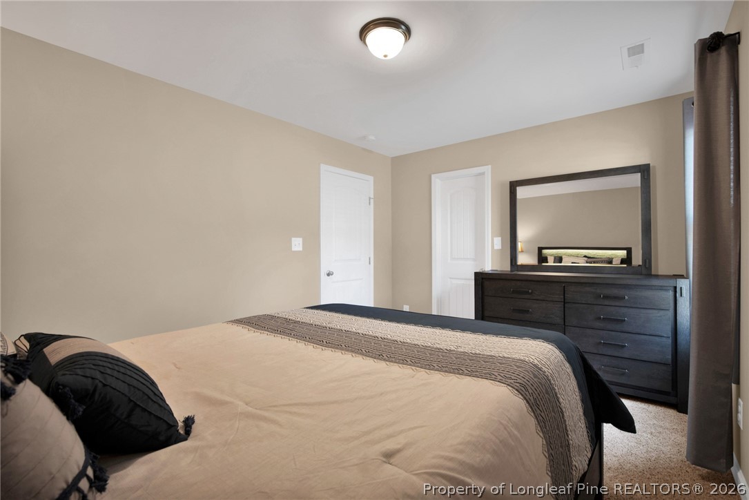 207 Pinetop Drive Carthage, NC 28327 - Photo 28 of 50 a bedroom with a bed and a flat screen tv