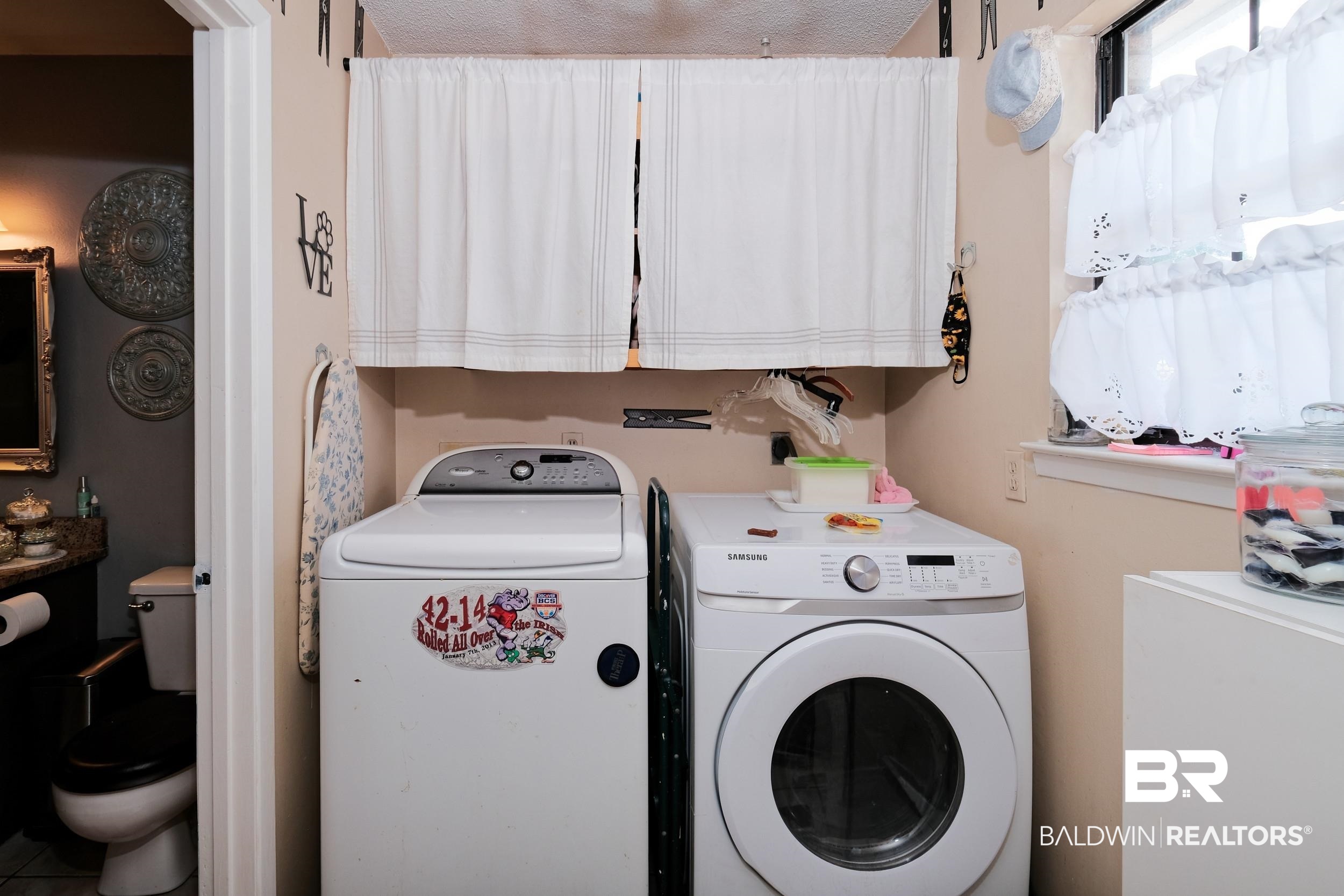 504 Ariel Avenue Foley, AL 36535 - Photo 20 of 33 Laundry area featuring cabinets and washer and dryer