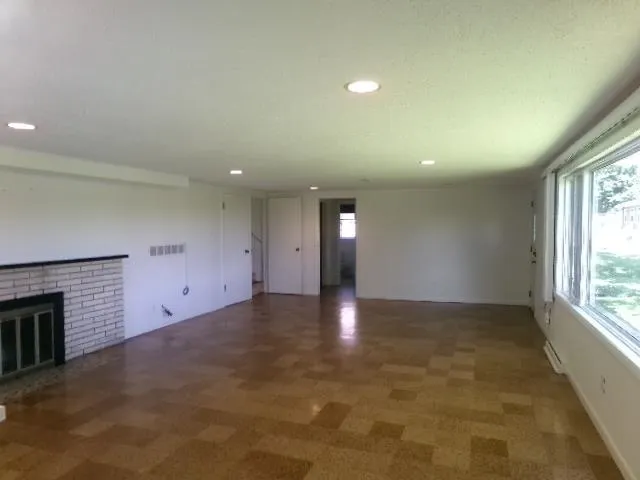 a kitchen with a sink a stove a refrigerator and white cabinets