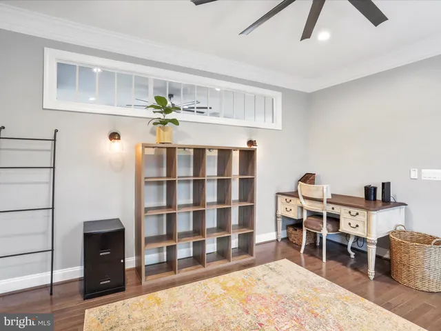 a bedroom with a bed and a ceiling fan