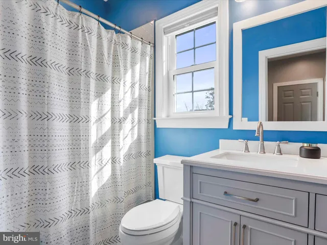 a bedroom with a bed and a ceiling fan